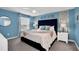 Blue bedroom with a large bed and a tufted headboard at 1870 Summer Dr, Davenport, FL 33897