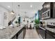 Modern kitchen with breakfast bar, stainless steel appliances & granite countertops at 1870 Summer Dr, Davenport, FL 33897