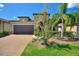 One story house with a brown garage door and landscaping at 547 Vigo St, Davenport, FL 33837