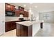 Modern kitchen featuring dark wood cabinets and island at 547 Vigo St, Davenport, FL 33837