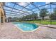 Inviting screened pool and spa with brick pavers at 334 Chadwick Dr, Davenport, FL 33837