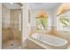 Spa-like bathroom with soaking tub and walk-in shower at 334 Chadwick Dr, Davenport, FL 33837