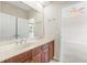 Bathroom with double vanity and access to bedroom at 334 Chadwick Dr, Davenport, FL 33837