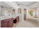 Large bathroom with double vanities, soaking tub, and walk-in shower at 334 Chadwick Dr, Davenport, FL 33837