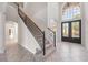 Grand two-story entryway with elegant staircase and double doors at 334 Chadwick Dr, Davenport, FL 33837