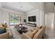 Bright living room with large TV and sliding doors leading to the pool at 334 Chadwick Dr, Davenport, FL 33837