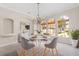 Elegant dining room with chandelier and arched windows, seating four at 334 Chadwick Dr, Davenport, FL 33837