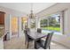 Bright breakfast nook with pool view and a rustic wooden table at 334 Chadwick Dr, Davenport, FL 33837