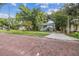 House with a brick-paved street in a tree-lined neighborhood, offering curb appeal and convenience at 31 W Harding St, Orlando, FL 32806