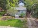 Quaint bungalow-style home situated on a large lot with a grassy yard and mature trees at 31 W Harding St, Orlando, FL 32806