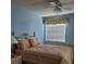 Bright bedroom with a double bed and light blue walls at 6182 Willowpointe # B201, Orlando, FL 32822