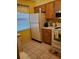 Condo kitchen with wood cabinets, white appliances, and tile floor at 6182 Willowpointe # B201, Orlando, FL 32822