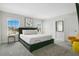 Main bedroom with king-size bed, gray carpet, and large windows at 1552 Plunker Dr, Davenport, FL 33896