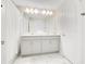 Bathroom with double vanity, white cabinets and marble tile floors at 1552 Plunker Dr, Davenport, FL 33896