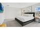 Main bedroom with king-size bed, gray carpet, and large windows at 1552 Plunker Dr, Davenport, FL 33896