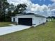 Modern house exterior with a white and black color scheme, showcasing the rear of the house at 15096 Sw 51St Ave, Ocala, FL 34473