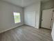 Well-lit bedroom with wood-look floors and double door closet at 15096 Sw 51St Ave, Ocala, FL 34473