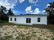 Modern house exterior with a white and black color scheme and a patio at 15096 Sw 51St Ave, Ocala, FL 34473