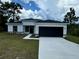 Modern house exterior with a white and black color scheme and a two-car garage at 15096 Sw 51St Ave, Ocala, FL 34473