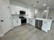 Modern kitchen with white cabinets, stainless steel appliances, and quartz countertops at 15096 Sw 51St Ave, Ocala, FL 34473