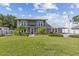 Two-story home with metal roof, balcony and landscaping at 7220 Grace Rd, Orlando, FL 32819
