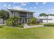 Two-story house with gray exterior, walkway, and palm trees at 7220 Grace Rd, Orlando, FL 32819