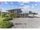 Two-story house with gray exterior, paver driveway, and lush landscaping at 7220 Grace Rd, Orlando, FL 32819