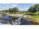 Steps leading down to a lakefront dock and sandy beach at 7220 Grace Rd, Orlando, FL 32819