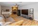 Gathering room with gray sectional sofa, stone fireplace, and large TV at 7220 Grace Rd, Orlando, FL 32819