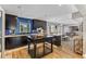 Modern kitchen with dark cabinetry, blue tile backsplash, and large island at 7220 Grace Rd, Orlando, FL 32819