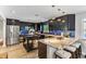Modern kitchen with dark cabinetry, granite countertops, and breakfast bar at 7220 Grace Rd, Orlando, FL 32819