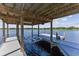 Covered boat lift and dock with beautiful lake view at 7220 Grace Rd, Orlando, FL 32819