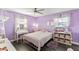 Bedroom with a full-size bed and lavender walls at 7220 Grace Rd, Orlando, FL 32819