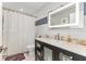 Modern bathroom with dark vanity, LED mirror, and shower at 7220 Grace Rd, Orlando, FL 32819