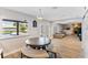 Casual dining area with round table and bench seating, overlooking the pool and lake at 7220 Grace Rd, Orlando, FL 32819