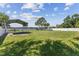Spacious backyard with a grassy area, shed and lake view at 7220 Grace Rd, Orlando, FL 32819