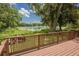 Deck overlooking a peaceful lake, surrounded by greenery at 3355 Scarlet Dr, Sanford, FL 32773