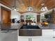 Kitchen with farmhouse sink, custom cabinetry, and wood beamed ceiling at 3355 Scarlet Dr, Sanford, FL 32773
