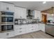 Modern kitchen with white cabinets, stainless steel appliances, and granite countertops at 3355 Scarlet Dr, Sanford, FL 32773