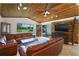 Living room featuring leather sectionals, wood accent wall, and water views at 3355 Scarlet Dr, Sanford, FL 32773