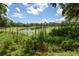 Picturesque lake view with lush greenery and blue sky at 3355 Scarlet Dr, Sanford, FL 32773