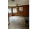 Simple bedroom with wood paneled walls and tile floors at 3355 Scarlet Dr, Sanford, FL 32773