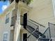 Exterior view of condo building with stairs and landscaping at 1059 S Hiawassee Rd # 1824, Orlando, FL 32835