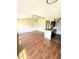 Spacious living room with wood floors and access to kitchen at 1059 S Hiawassee Rd # 1824, Orlando, FL 32835