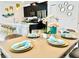Dining area with table set for six, adjacent to kitchen at 962 Splash Shot Pl, Davenport, FL 33896