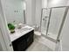 Bathroom with shower, single vanity, and white tile at 962 Splash Shot Pl, Davenport, FL 33896