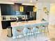 Modern kitchen with island, quartz countertops, and dark cabinets at 962 Splash Shot Pl, Davenport, FL 33896