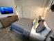 Serene bedroom with a comfortable bed, dresser and large TV at 962 Splash Shot Pl, Davenport, FL 33896