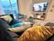 Spacious living room features a large TV, comfortable seating, and stylish decor at 962 Splash Shot Pl, Davenport, FL 33896