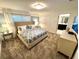 Calm and sophisticated bedroom with neutral tones and ensuite bathroom access at 962 Splash Shot Pl, Davenport, FL 33896